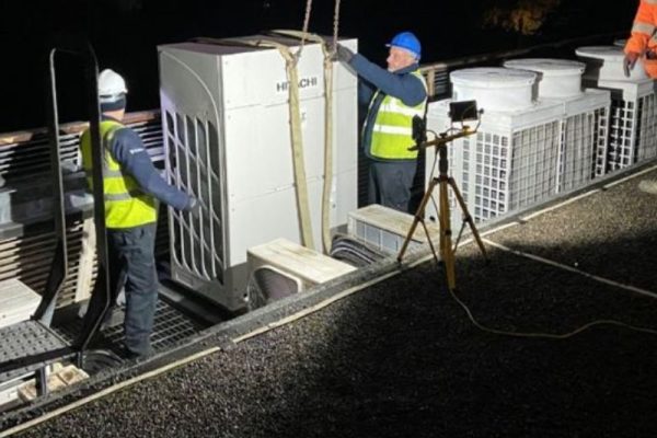 Chillaire installing Hitachi air conditioning unit on a roof