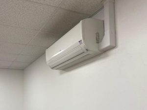 Simple air conditioning unit on white wall