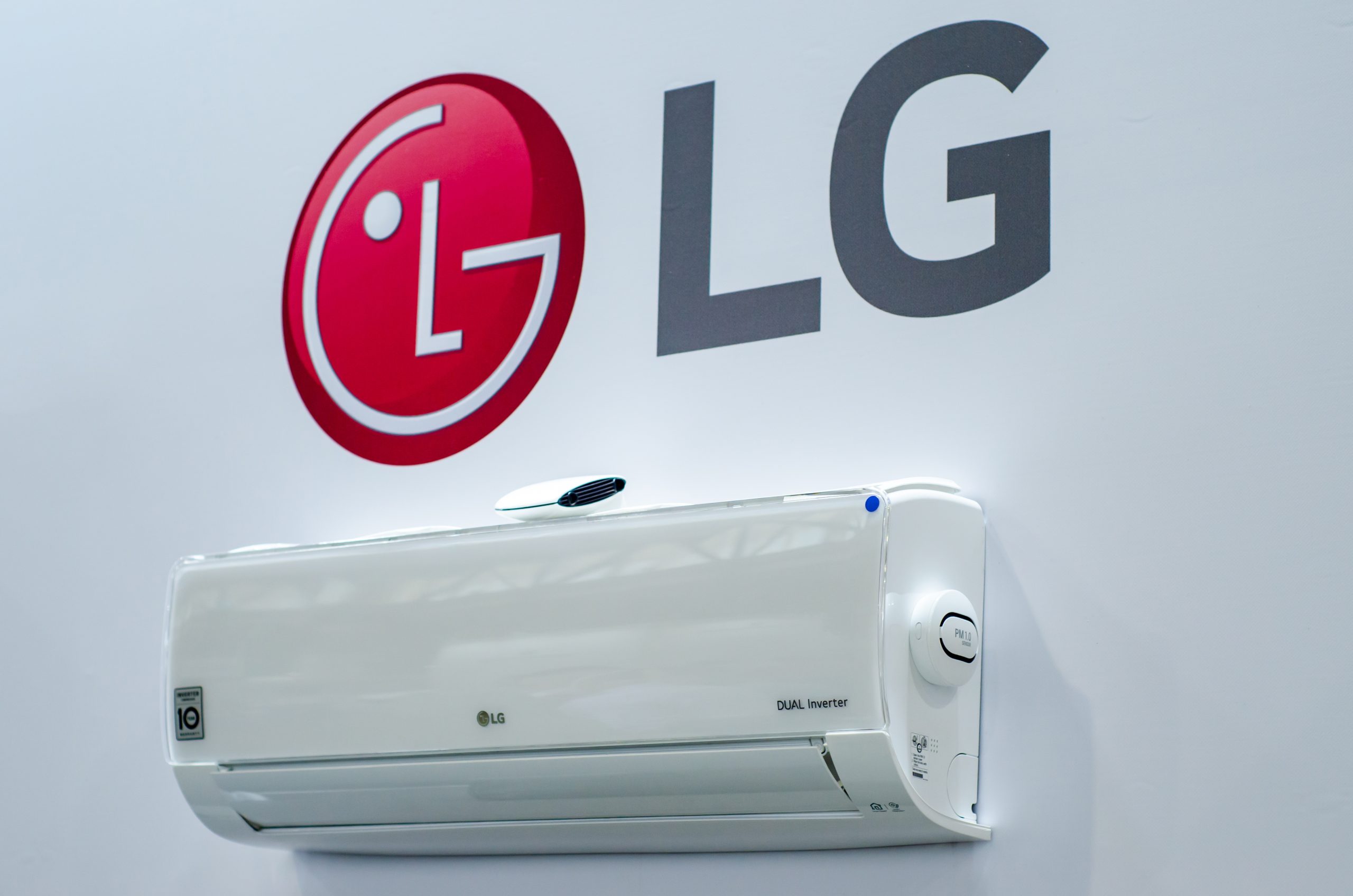 Brand new LG air con unit on white wall with LG logo above it