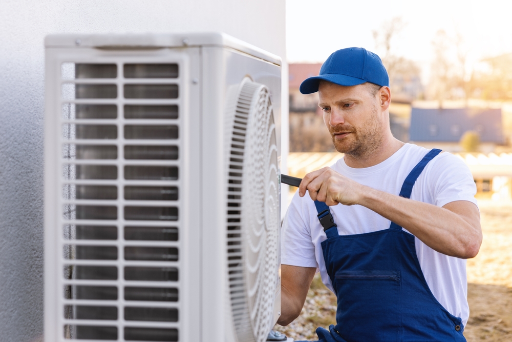 Man fixing outdoor air con unit